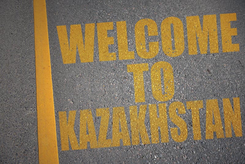 asphalt road with text welcome to kazakhstan near yellow line. royalty free illustration