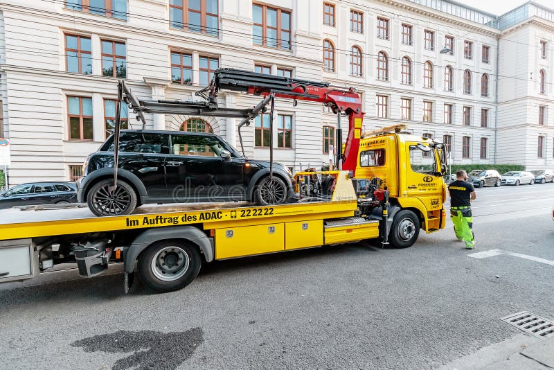 Tow truck takes the car for wrong Parking in the city street royalty free stock photos