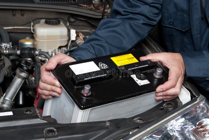 Auto mechanic replacing car battery royalty free stock photos