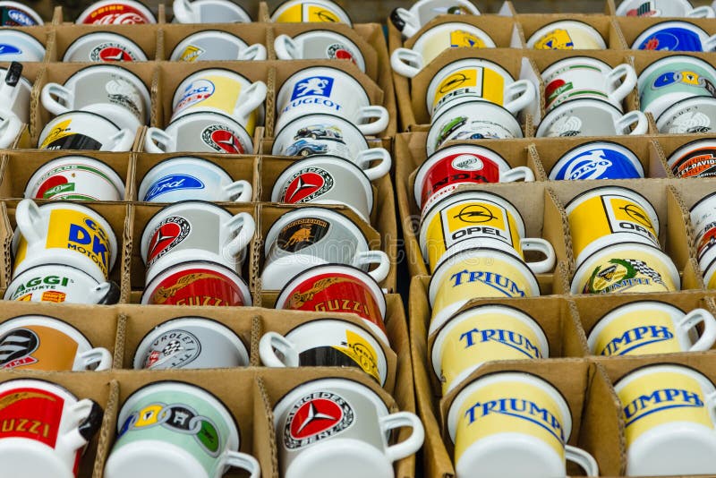 Background of enamel mugs with logos of automobile firms. BERLIN - JUNE 14, 2015: Background of enamel mugs with logos of automobile firms. The Classic Days on royalty free stock images