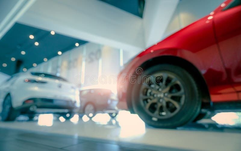 Blurred SUV car parked in modern showroom. Car dealership and auto leasing concept. Automotive industry. Modern luxury showroom. Rear view new car parked in stock photography