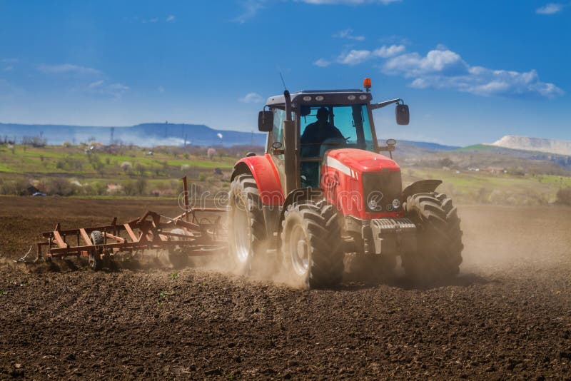 Brand new red tractor working royalty free stock photos
