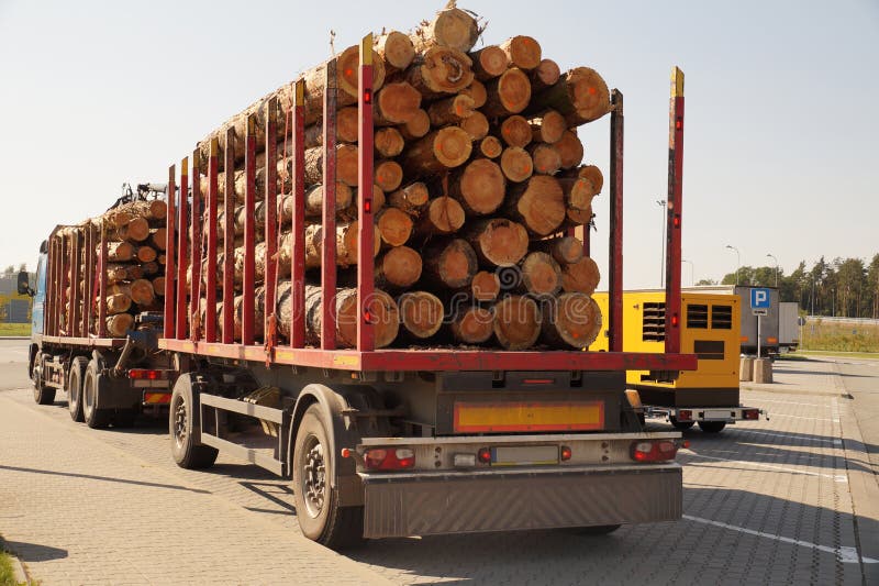Break at work. Truck with semi-trailers for transporting wood on stock photo