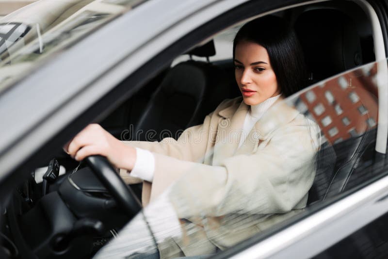 Businesswoman driving the luxury car. Girl posing in her car royalty free stock photos