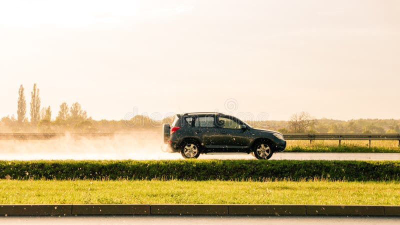 Car going fast on raining scenery. Suv car going fast on raining scenery royalty free stock photos