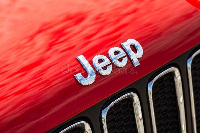 Chromed Jeep car logo. Saint-Petersburg, Russia - August 13, 2018: Chromed Jeep car logo mounted at red SUV car hood, close-up photo with selective focus royalty free stock photo