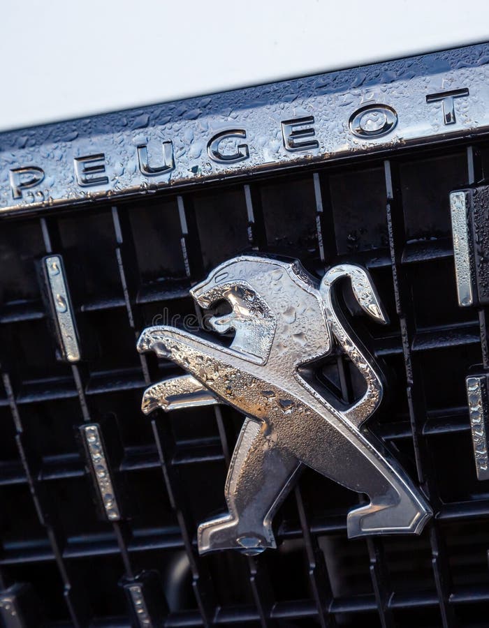 Close-up of the logo placed on the front bumper of the white Peugeot SUV car. Cognac, France - February 21, 2020:close-up of the logo placed on the front bumper royalty free stock photos