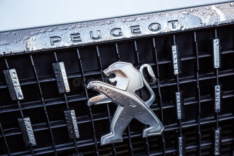 Close-up of the logo placed on the front bumper of the white Peugeot SUV car. Cognac, France - February 21, 2020:close-up of the logo placed on the front bumper stock photography