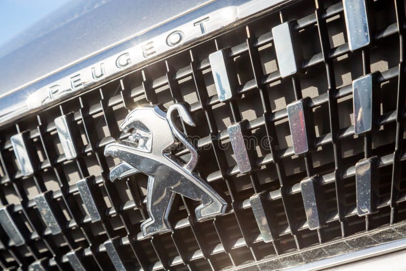 Close-up of the logo placed on the front bumper of the white Peugeot SUV car. Cognac, France - February 21, 2020:close-up of the logo placed on the front bumper royalty free stock photo