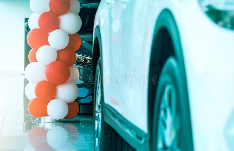 Closeup headlamp light of new luxury SUV car parked in modern showroom. Car dealership showroom office. Automobile leasing concept. Automotive industry stock image