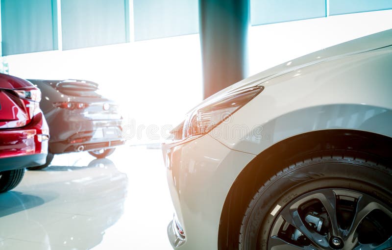 Closeup luxury SUV car parked in modern showroom. Red, white, and grey SUV car in showroom. Car dealership concept. Automotive. Industry. Electric car business stock images