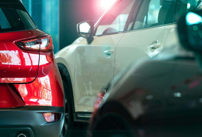 Closeup luxury SUV car with sport design parked in modern showroom. Rear view of red shiny SUV car in showroom. Car dealership. Concept. Automotive industry stock photography