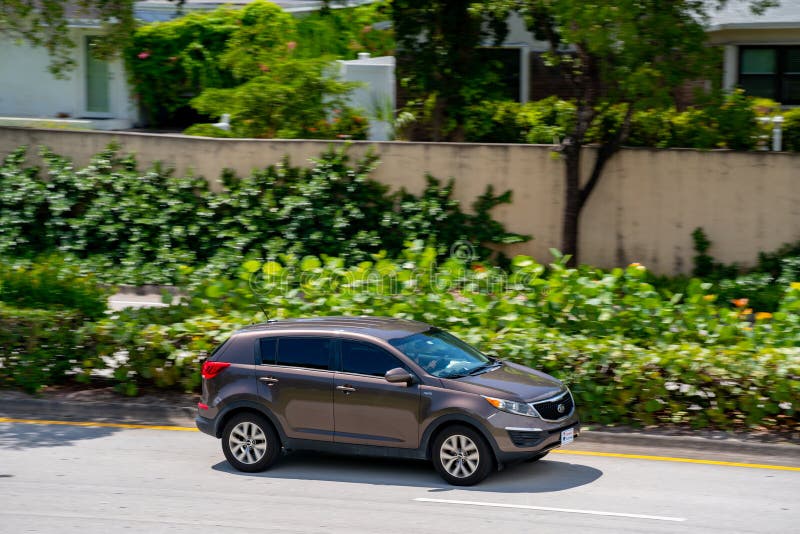 Compact KIA SUV driving fast on a laned road. Fort Lauderdale, FL, USA - August 16, 2020: Compact KIA SUV driving fast on a laned road stock photography