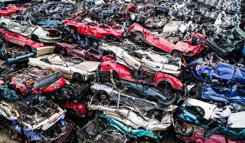 Destroyed scrapped cars stacked on a scrap yard. royalty free stock images