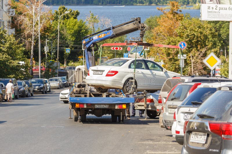 Evacuation from an expensive Mercedes car for an incorrect parking on a hot summer day. Russia, Samara, August 2017: evacuation from an expensive Mercedes car royalty free stock photo