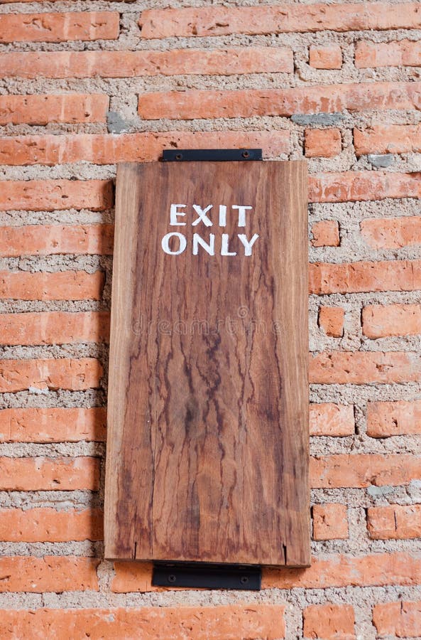 Exit only sign on brick wall stock photos