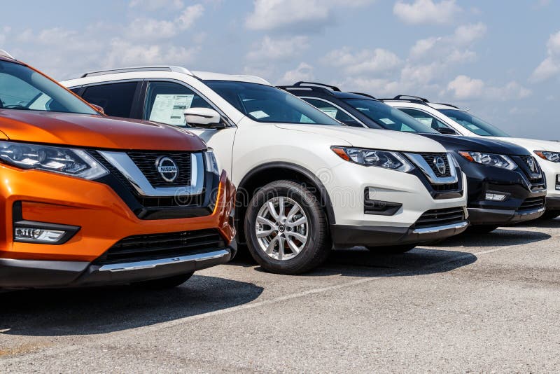 Fishers - Circa August 2018: New vehicles at a Nissan Car and SUV Dealership. Nissan is part of the Renault Nissan Alliance VIII. New vehicles at a Nissan Car royalty free stock photos