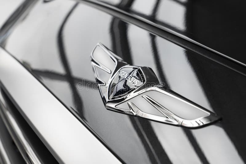 Genesis-the logo of a luxury sedan, Hyundai car brand on the hood of the car in the showroom close-up.  royalty free stock images