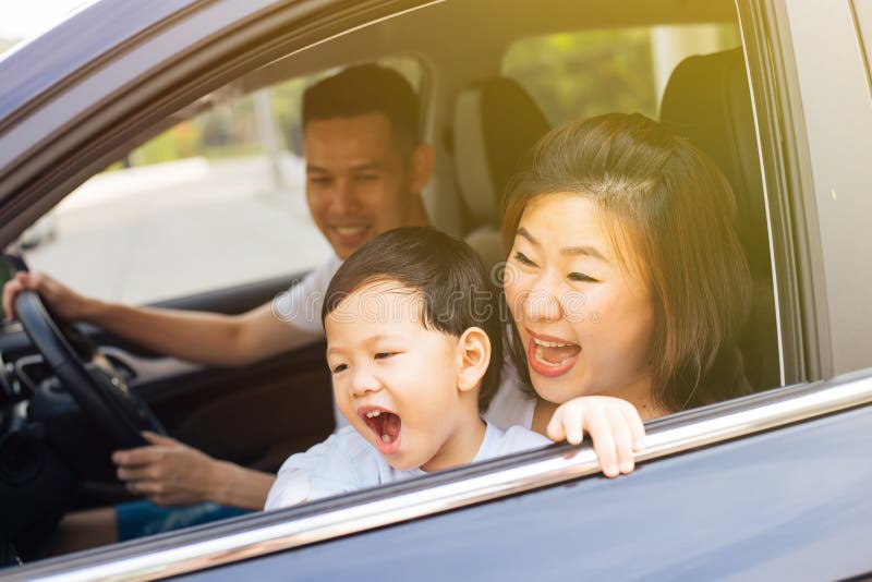 Happy Asian family is smiling and travelling on the road trip, going for a drive for vacation. Happy Asian family is smiling and travelling on the road trip stock photo