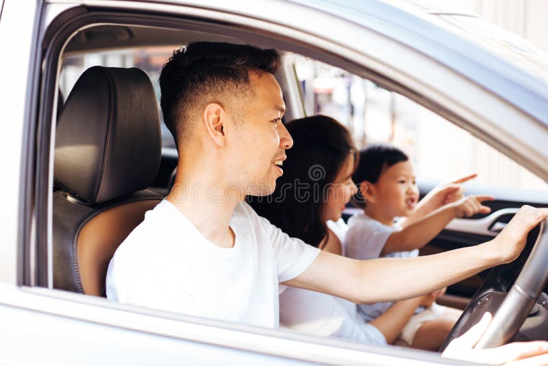 Happy Asian family is smiling and travelling on the road trip, going for a drive for vacation. Happy Asian family is smiling and travelling on the road trip stock photography