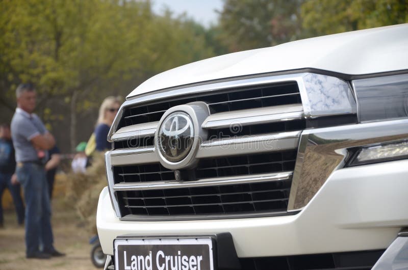 Toyota logo on Land Cruiser 200 AWD SUV front part. KHARKOV, UKRAINE - AUGUST 31, 2019: Toyota Land Cruiser 200 AWD SUV front with company logo. Toyota Motor royalty free stock images