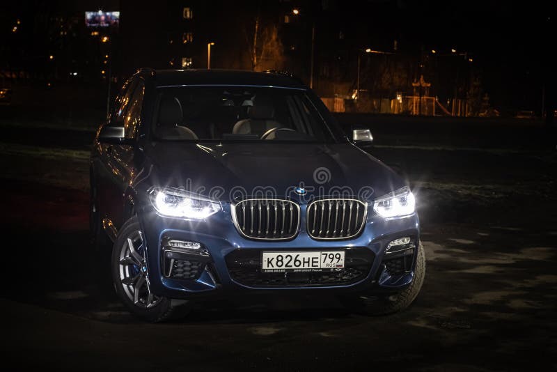 Moscow. Russia - December 06, 2019: The all-new BMW X3. Blue crossover stands on the street at night. Premium German SUV front. View royalty free stock image