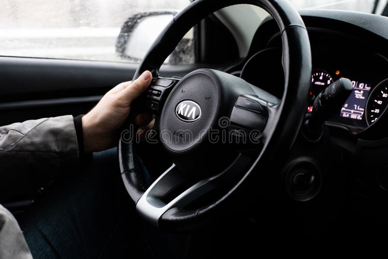 Moscow, Russia - January 2, 2020: Black steering wheel with the KIA logo close-up. The interior of a South Korean SUV KIA Rio X-. Line car. Male hand on a black royalty free stock images