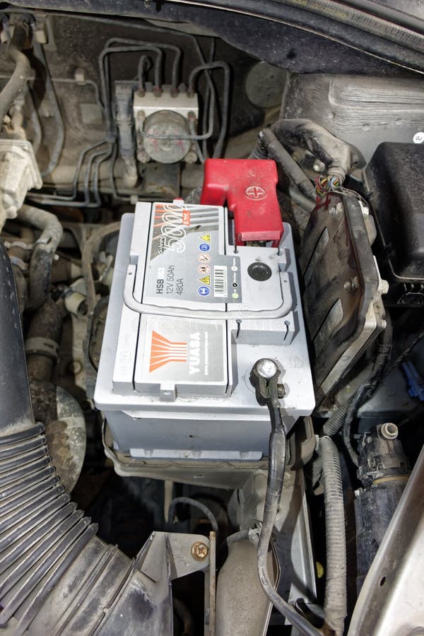 A Yuasa car battery in the engine bay of a Suzuki SX4 stock photos