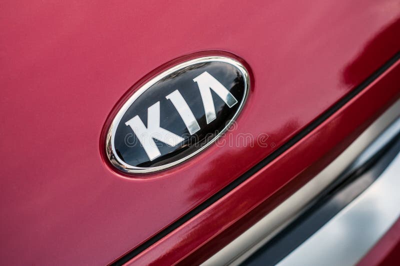 Kia logo on red SUV car front parked in the street. Mulhouse - France - 27 October 2019 - Closeup of Kia logo on red SUV car front parked in the street royalty free stock photography