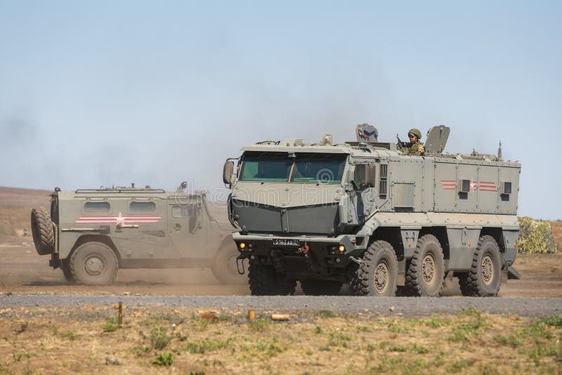 Multipurpose armored vehicle GAZ-233014 Tiger and Kamaz-63968 are moving in a military training ground. KADAMOVSKIY TRAINING GROUND, ROSTOV REGION, RUSSIA royalty free stock photos