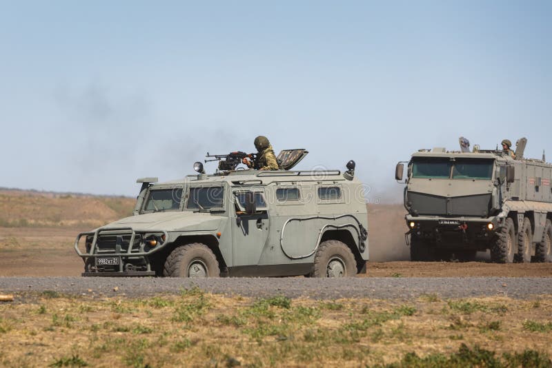 Multipurpose armored vehicle GAZ-233014 Tiger and Kamaz-63968 are moving in a military training ground. KADAMOVSKIY TRAINING GROUND, ROSTOV REGION, RUSSIA stock photos