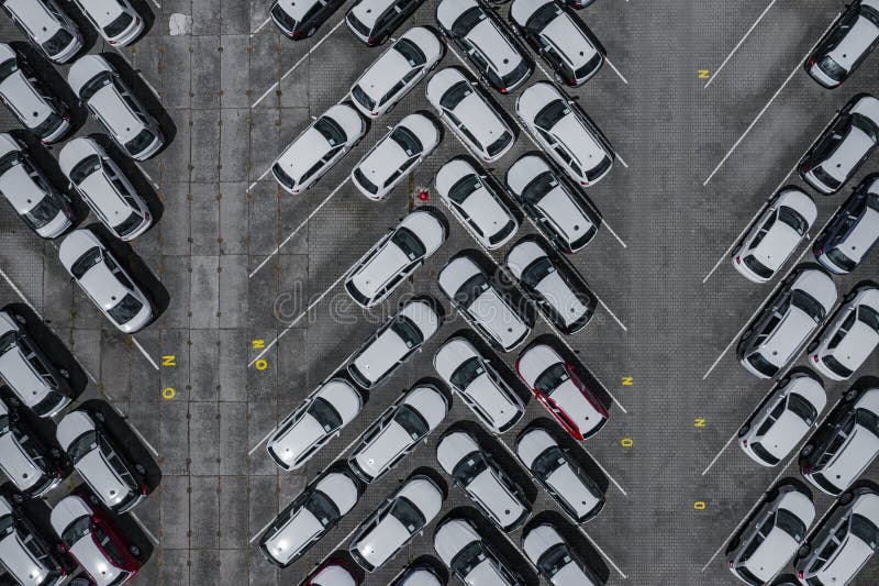 New car lined up aerial view. Port of import and export business logistic to dealership for sale. Automobile and automotive car royalty free stock photography