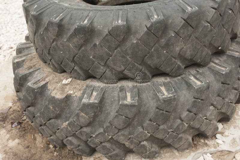 Old car tires from a KAMAZ truck in Russia. Old car tires from a KAMAZ truck.They are used in Russia to enclose wells or fences.Tires are changed in Russia twice royalty free stock photo