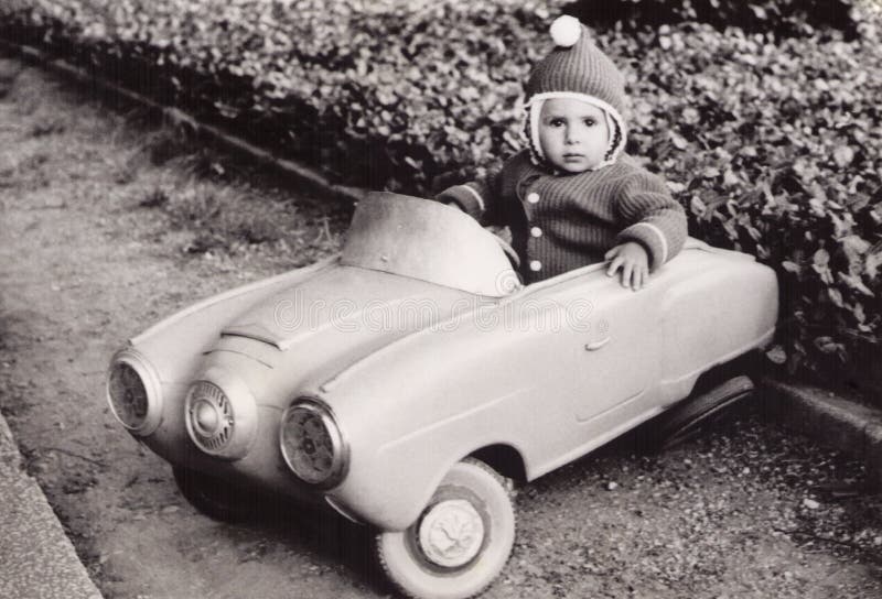 Old Photography of a little girl in a toy car. Old photography (1980) of a little girl in a toy car royalty free stock photos
