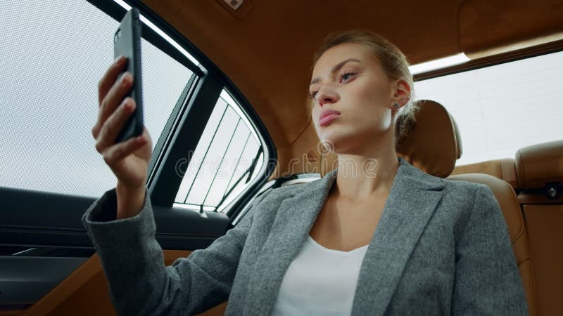 Closeup sexy businesswoman flirting on video call at car. Girl having video chat. Portrait of sexy businesswoman flirting on video call online at luxury car stock photo