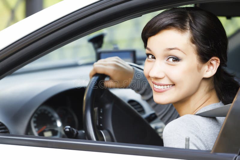 Pretty girl in a car. Smiling to you stock photo