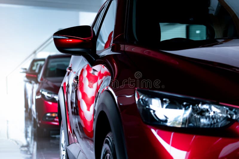 Red SUV car parked in modern showroom. New and luxury SUV compact car. Car dealership concept. Automotive industry. Automobile. Leasing business. Front view of stock image