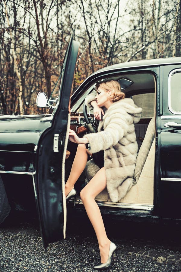 Retro collection car and auto repair by driver. Call girl in vintage car. sexy woman in fur coat. Travel and business. Trip or hitch hiking. Escort and security stock images