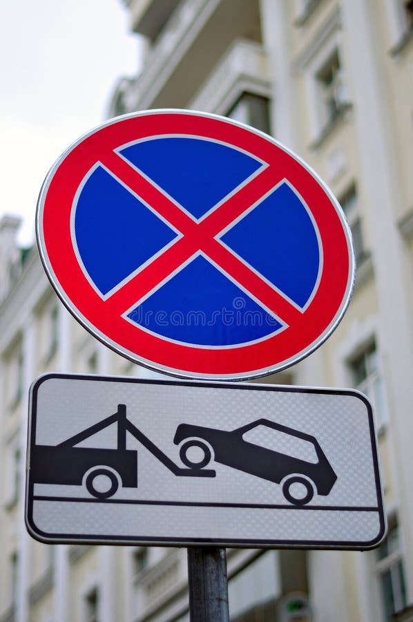 Road sign No stopping and parking and evacuation of cars. Road sign No stopping and parking also the plate about evacuation of incorrectly parked cars against stock photos