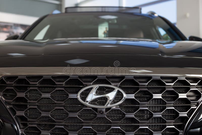 Russia, Izhevsk - January 23, 2020: Hyundai logo on a new car at a dealership showroom. Famous world brand. Prestigious cars stock photos