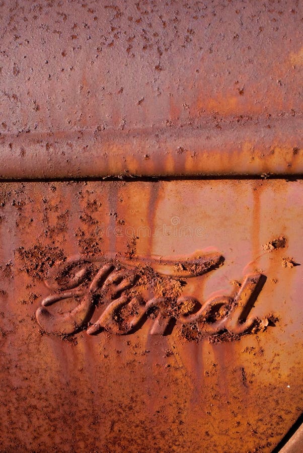 Rusty Antique Ford Truck Logo. Photo depicts Ford Logo on old rusty antique pickup truck royalty free stock photo