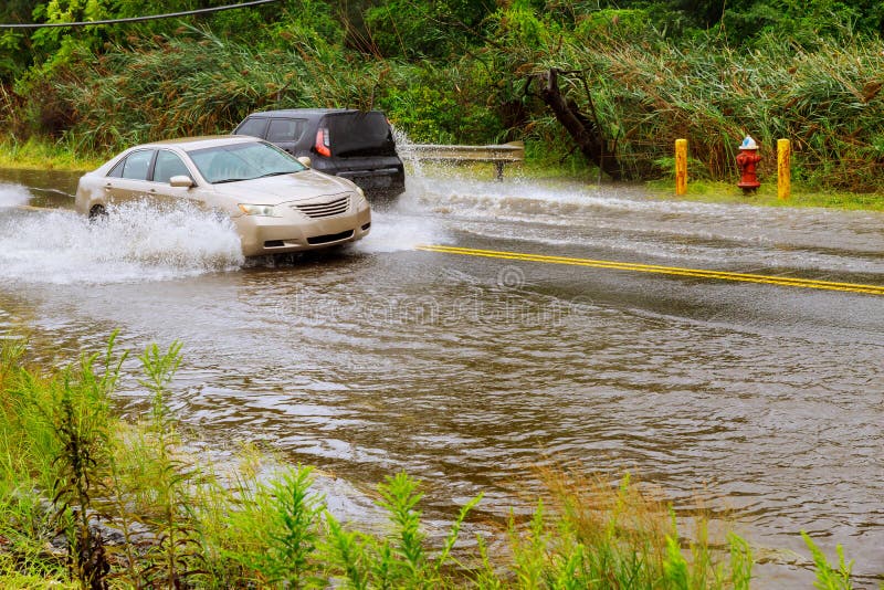 Splash by car as it goes through flood water after heavy rains of Harvey hurricane storm stock images