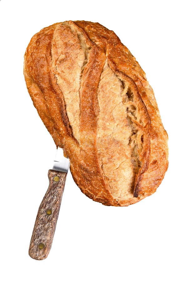 Still life of a loaf of country style bread with a knife stuck in the side of the loaf, isolated on white royalty free stock photos