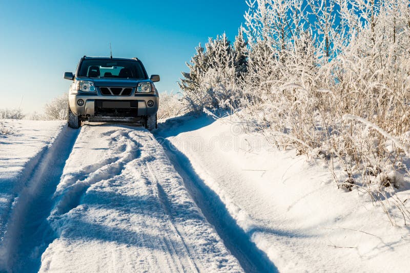 Suv car going through winter snowy road. Deep snow road difficult to drive, winter scene stock photo