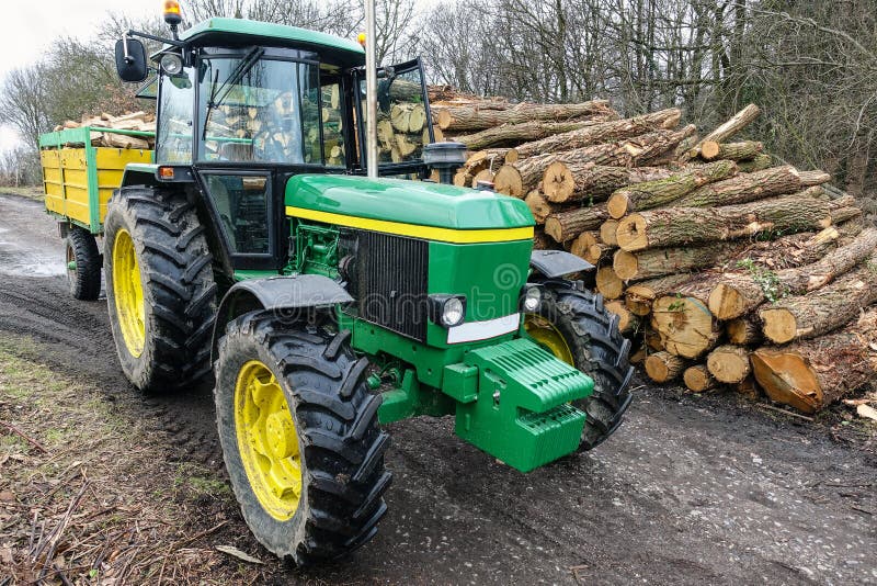 Tractor and pile of wood royalty free stock photos