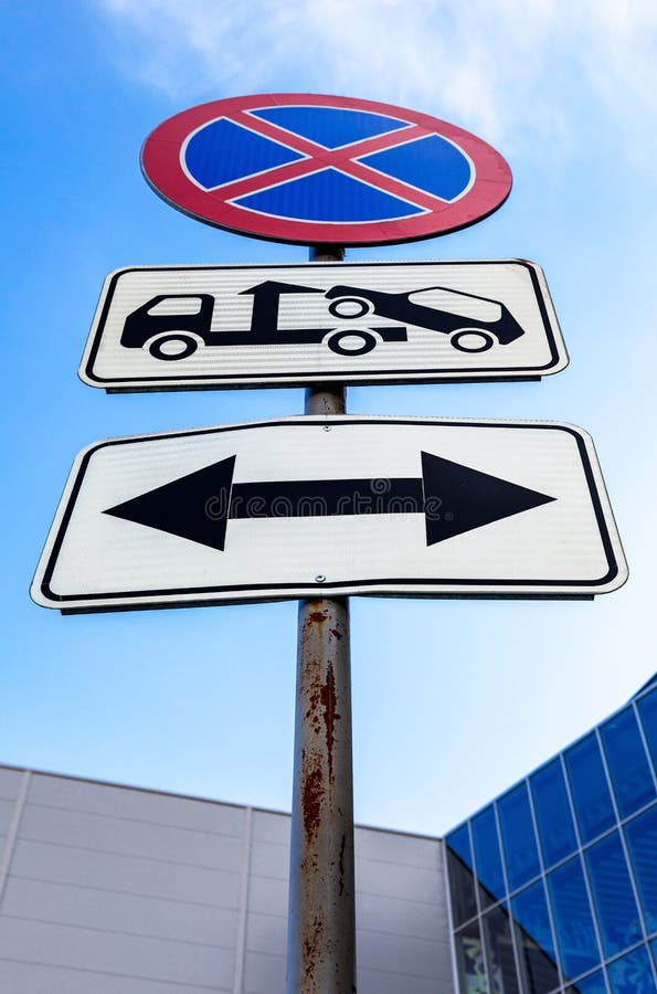 Traffic signs no parking and evacuation on tow truck. Traffic sign prohibiting stopping of vehicles. Road sign prohibiting parking. Evacuation on tow truck stock photos