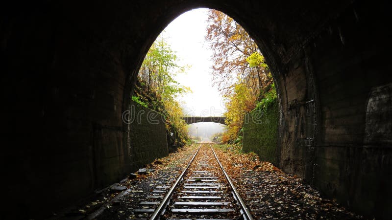 Underground Dark Train Rail Way Tunnel Exit with Light in the End. Underground Dark Train Rail Way Tunnel Exit with a Light in the End royalty free stock photos