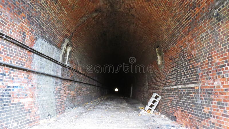 Underground Dark Train Rail Way Tunnel Exit with Light in the End. Underground Dark Train Rail Way Tunnel Exit with a Light in the End royalty free stock images