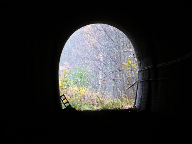 Underground Dark Train Rail Way Tunnel Exit with Light in the End. Underground Dark Train Rail Way Tunnel Exit with a Light in the End royalty free stock photo