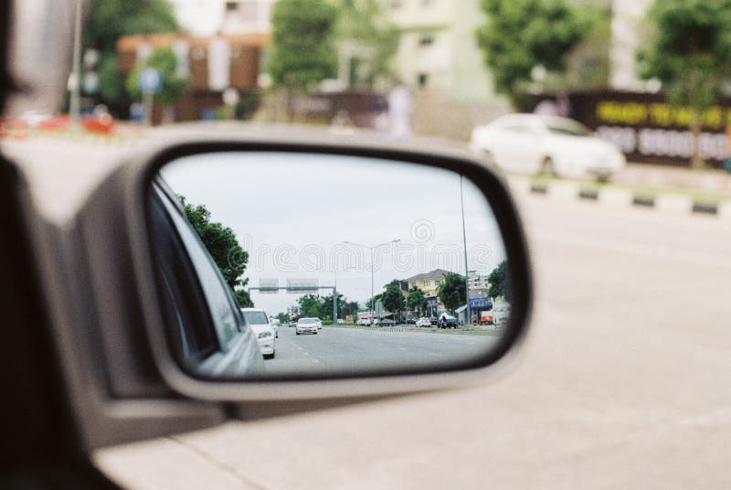 View through the automotive rear view mirror by film photography royalty free stock photo